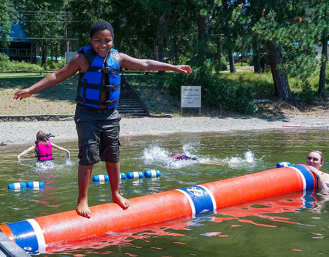 ElementaryArtPhoto2_2021 kid on log rolling in lake